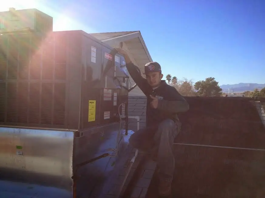 HVAC technician performing HVAC Inspection on a rooftop unit in Hoosick